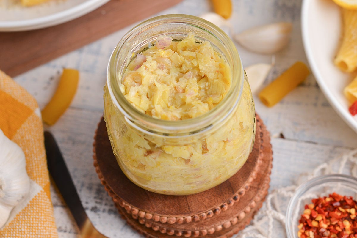 close up angled shot of jar of lemon pesto