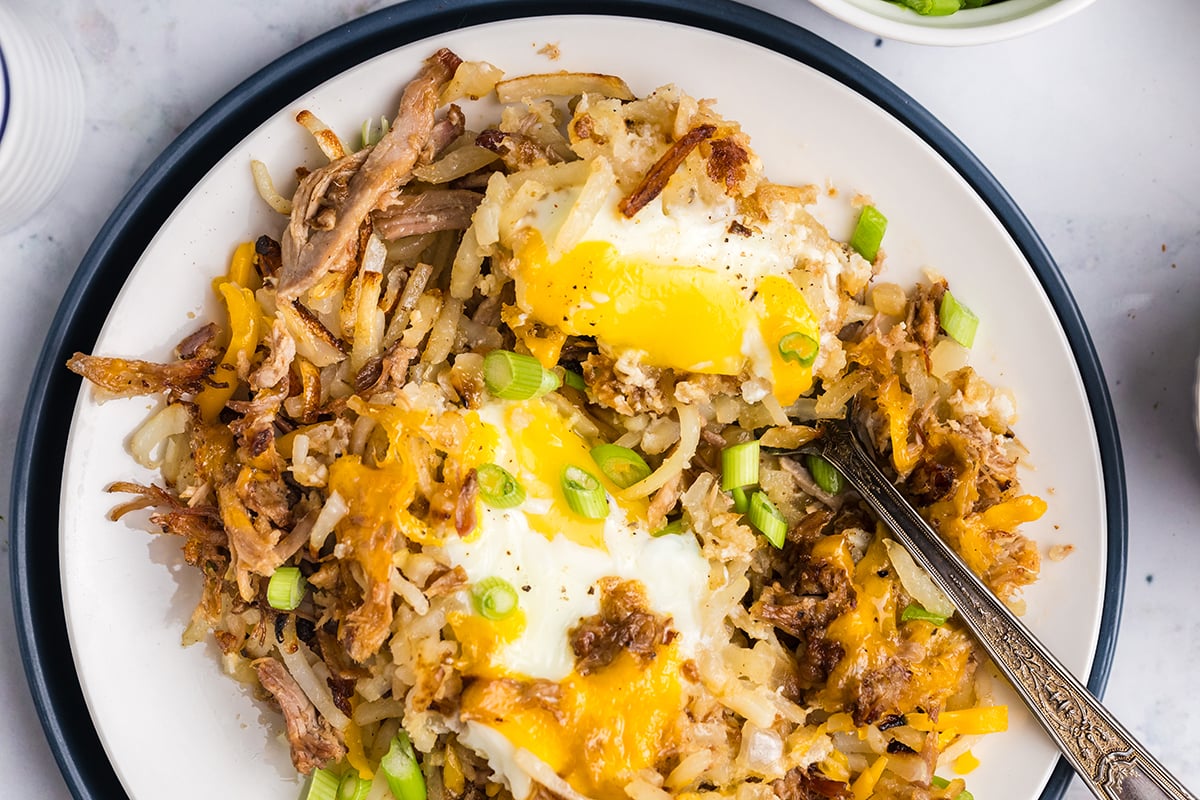 overhead shot of bbq pulled pork hash on plate with fork