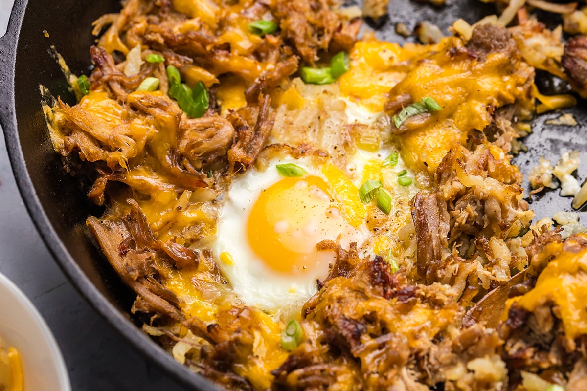 close up overhead shot of egg in hash skillet
