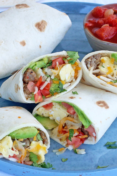 Plated breakfast burritos with salsa on a blue plate