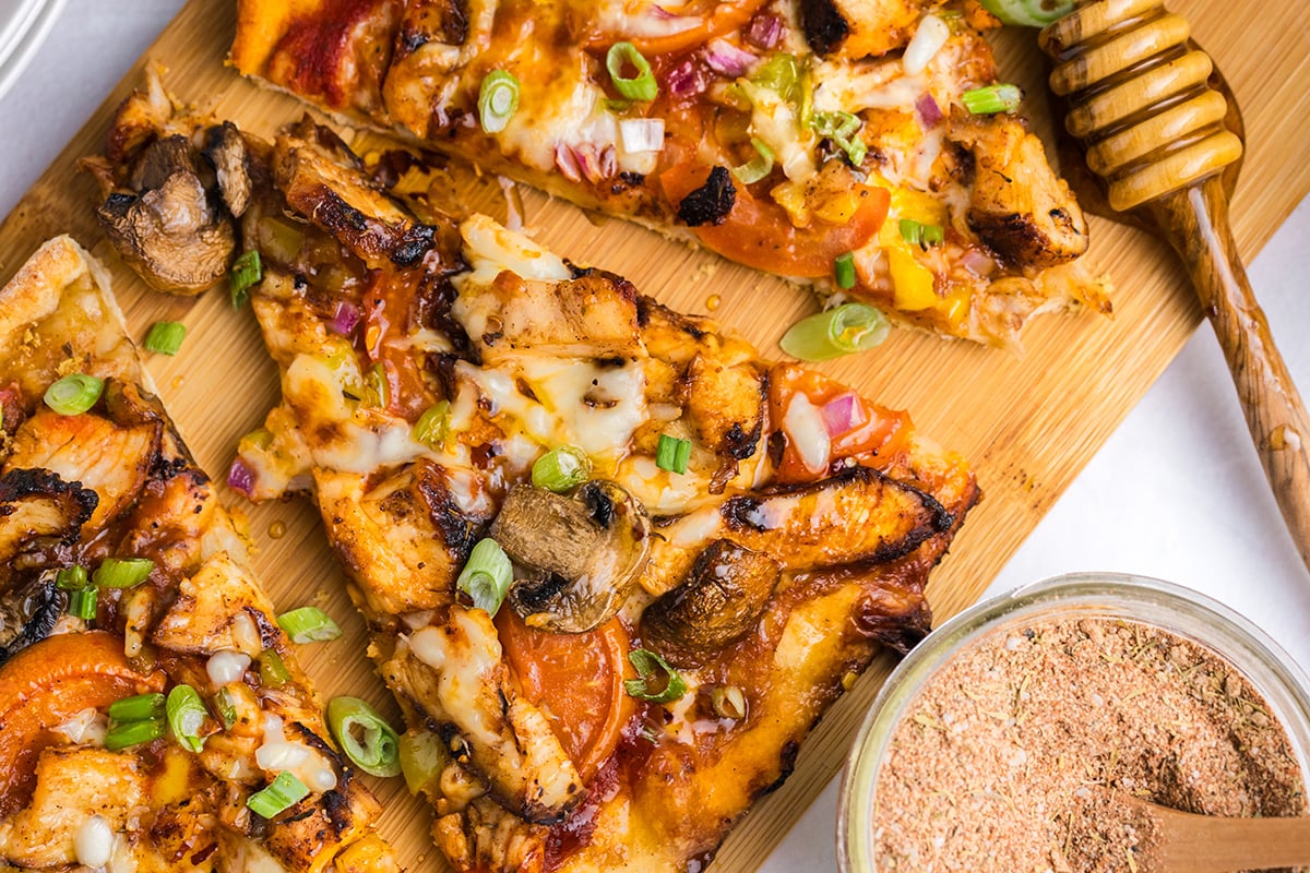 overhead shot of slices of pizza on wooden board
