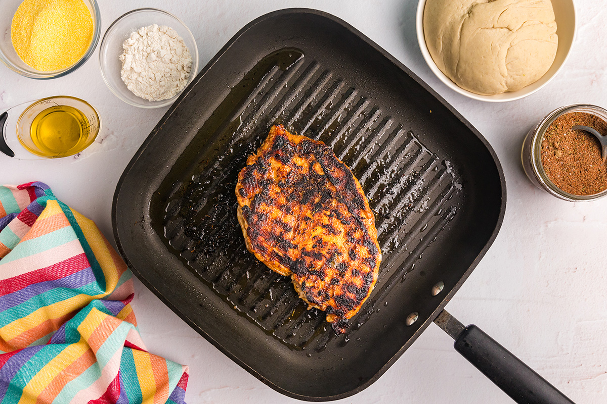 overhead shot of chicken cooking on skillet