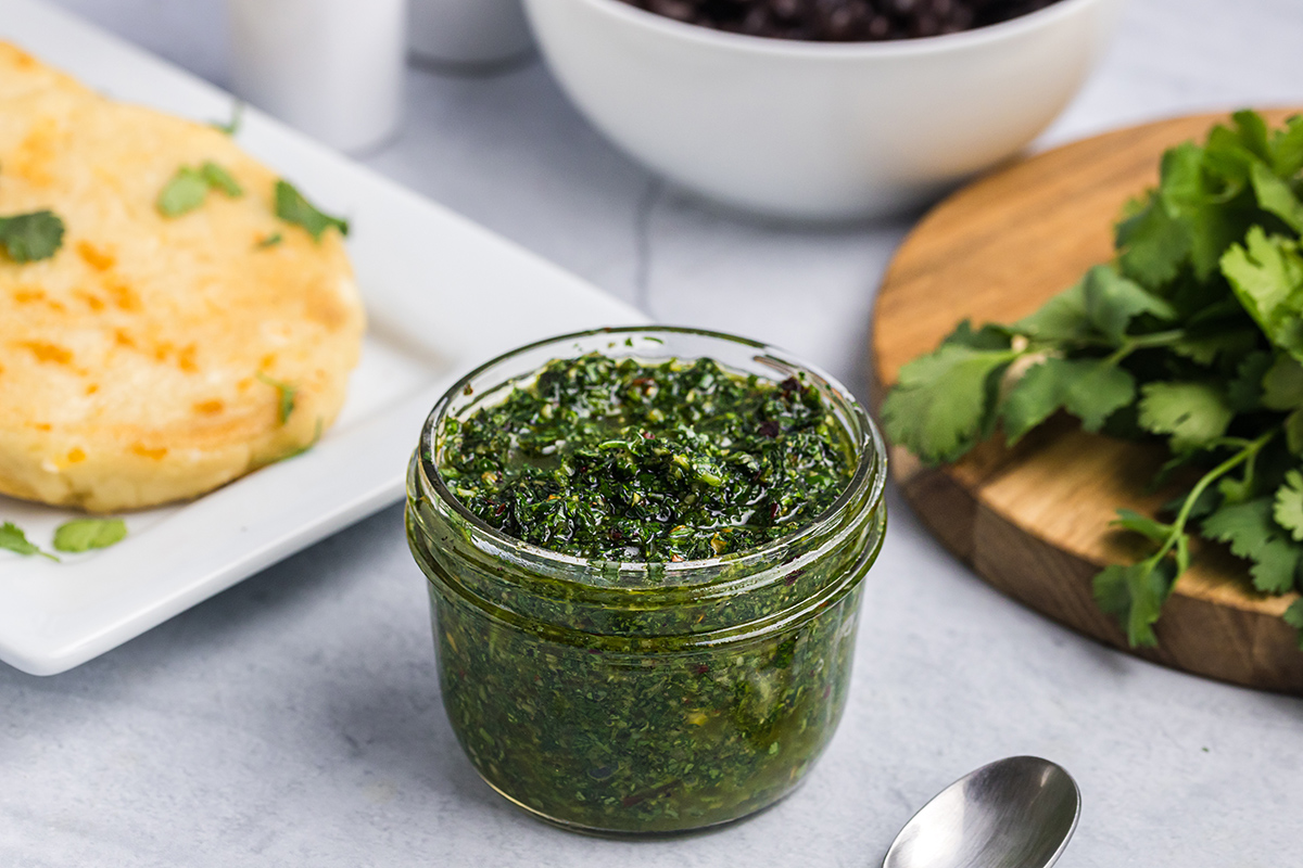 green chimichurri sauce recipe in a small glass bowl