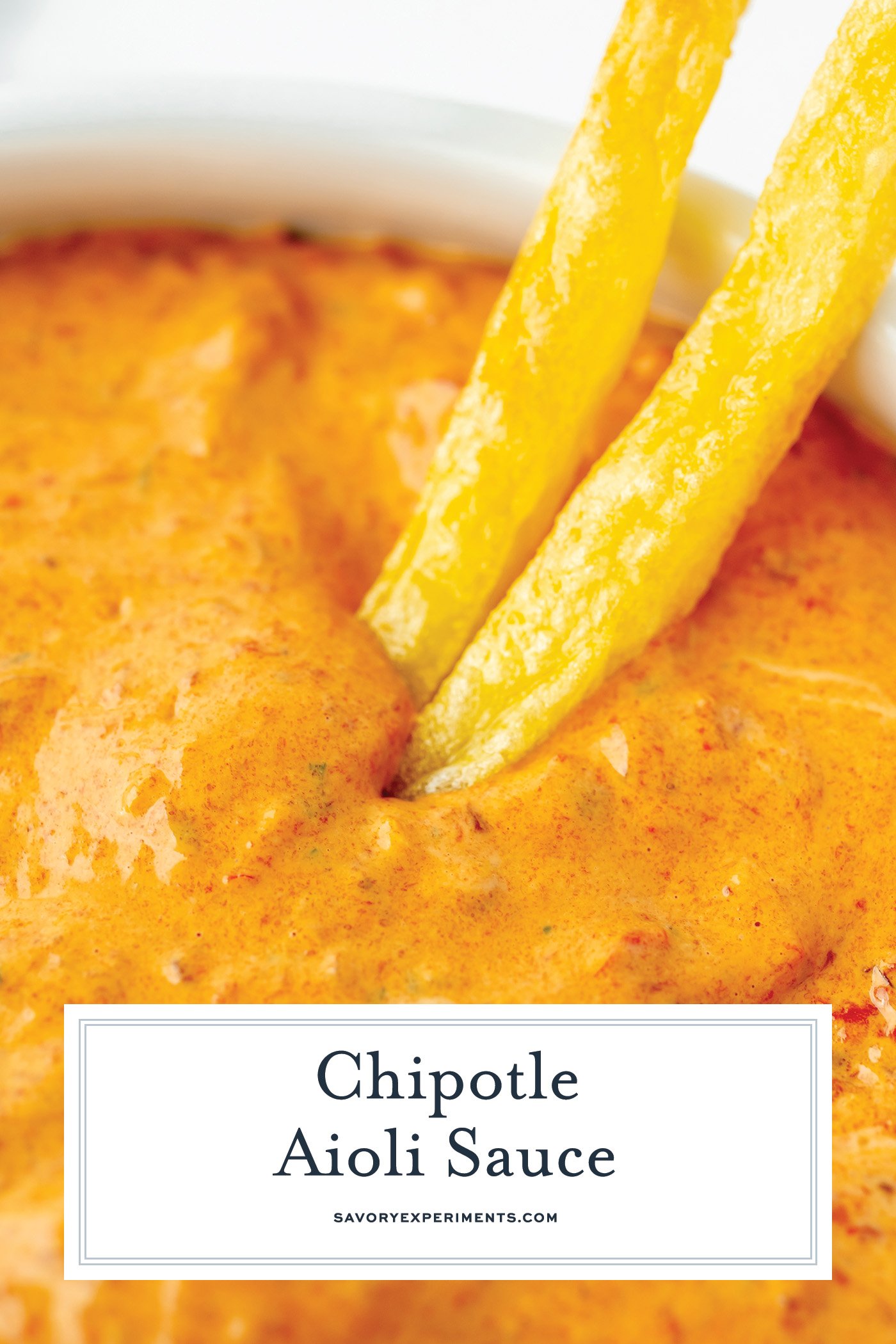 angled shot of two fries dipping into chipotle mayo with text overlay