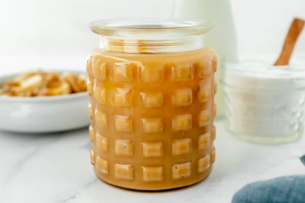 angled shot of jar of sweetened condensed milk caramel