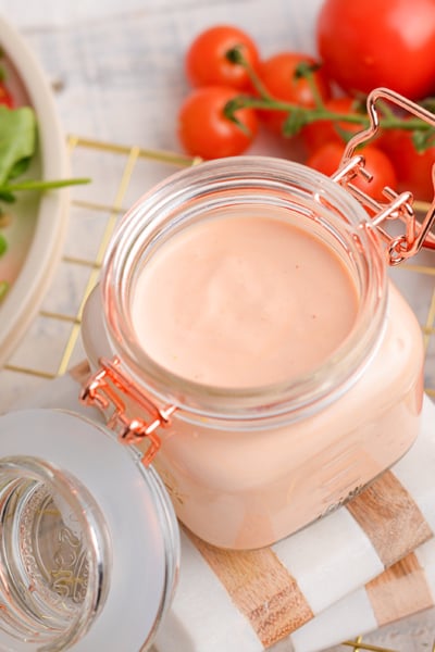 angled shot of creamy dressing in jar