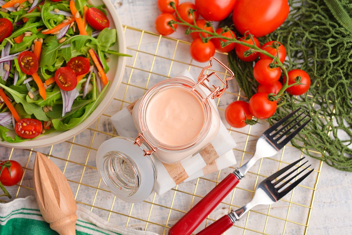 overhead shot of creamy tomato salad dressing in jar