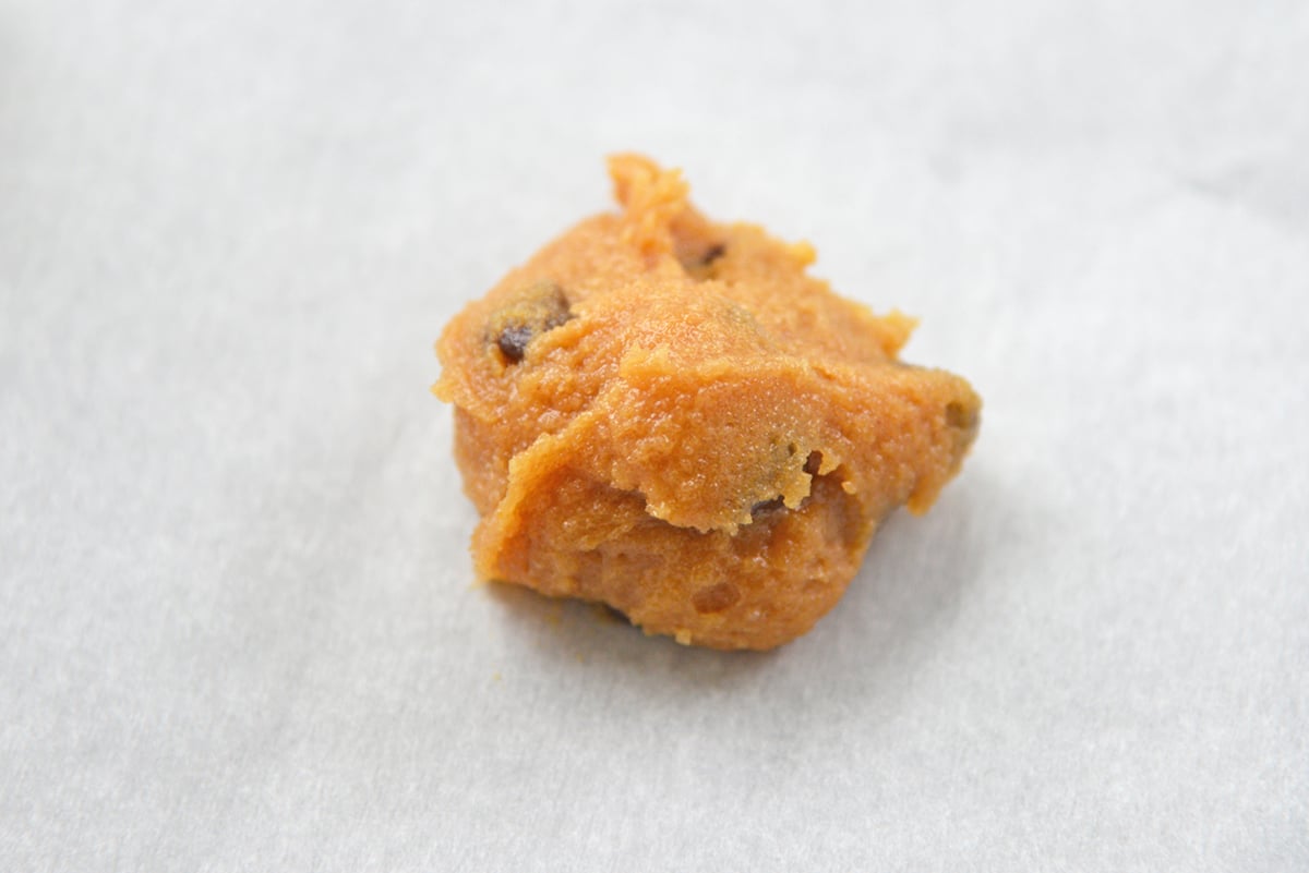 close up of flourless peanut butter cookie dough on parchment paper