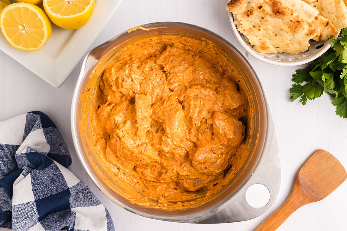 chicken pieces in bowl of marinade