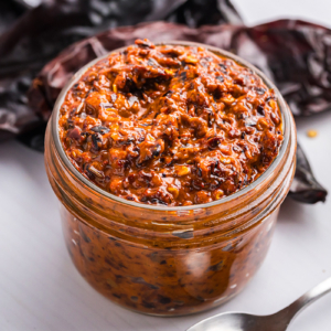 close up angled shot of jar of harissa sauce