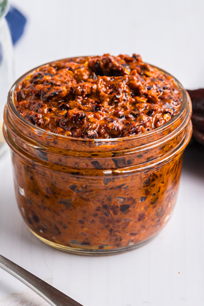 angled shot of jar of harissa sauce