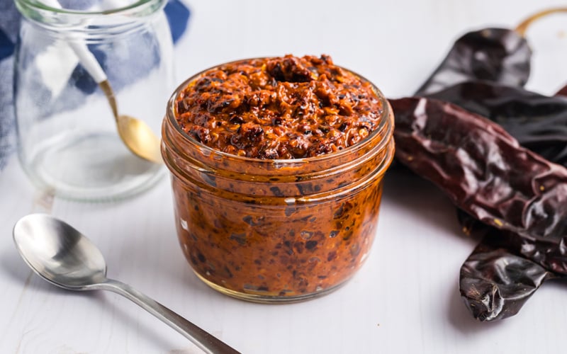 angled shot of jar of harissa sauce