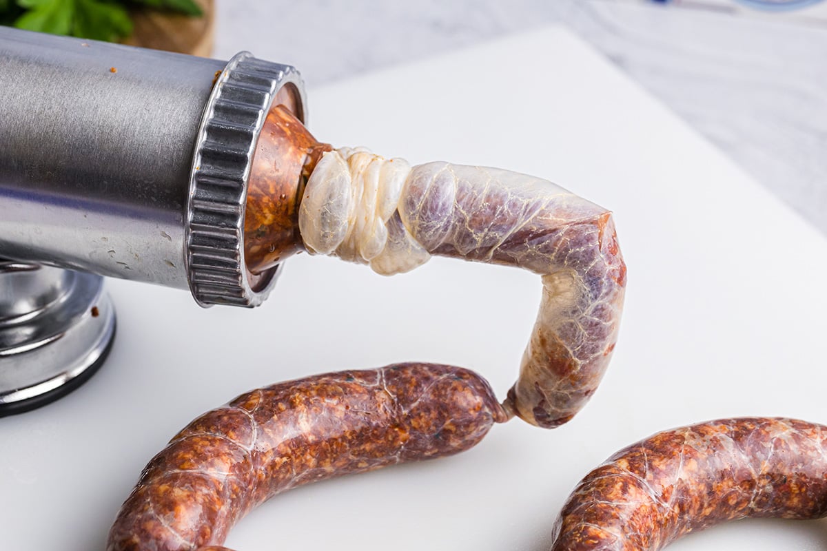 ground italian sausage stuffing into casing