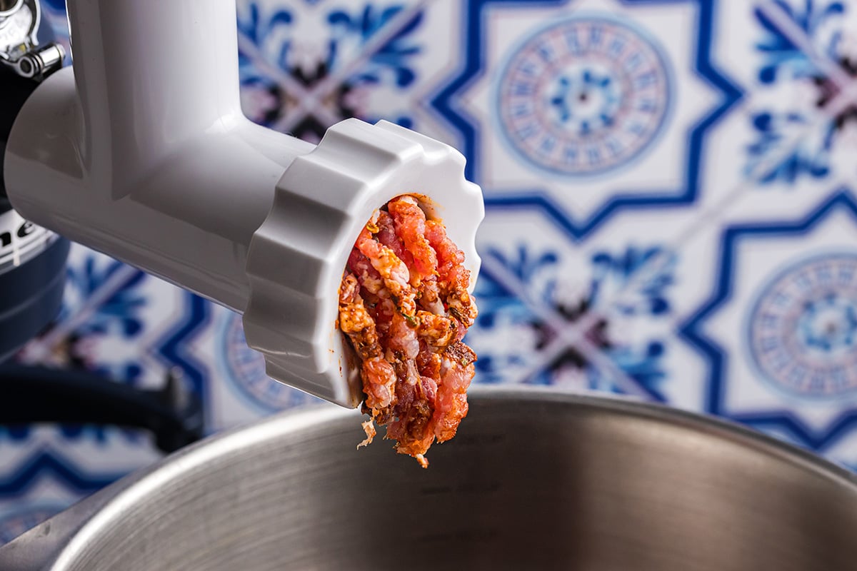 ground sausage coming out of machine