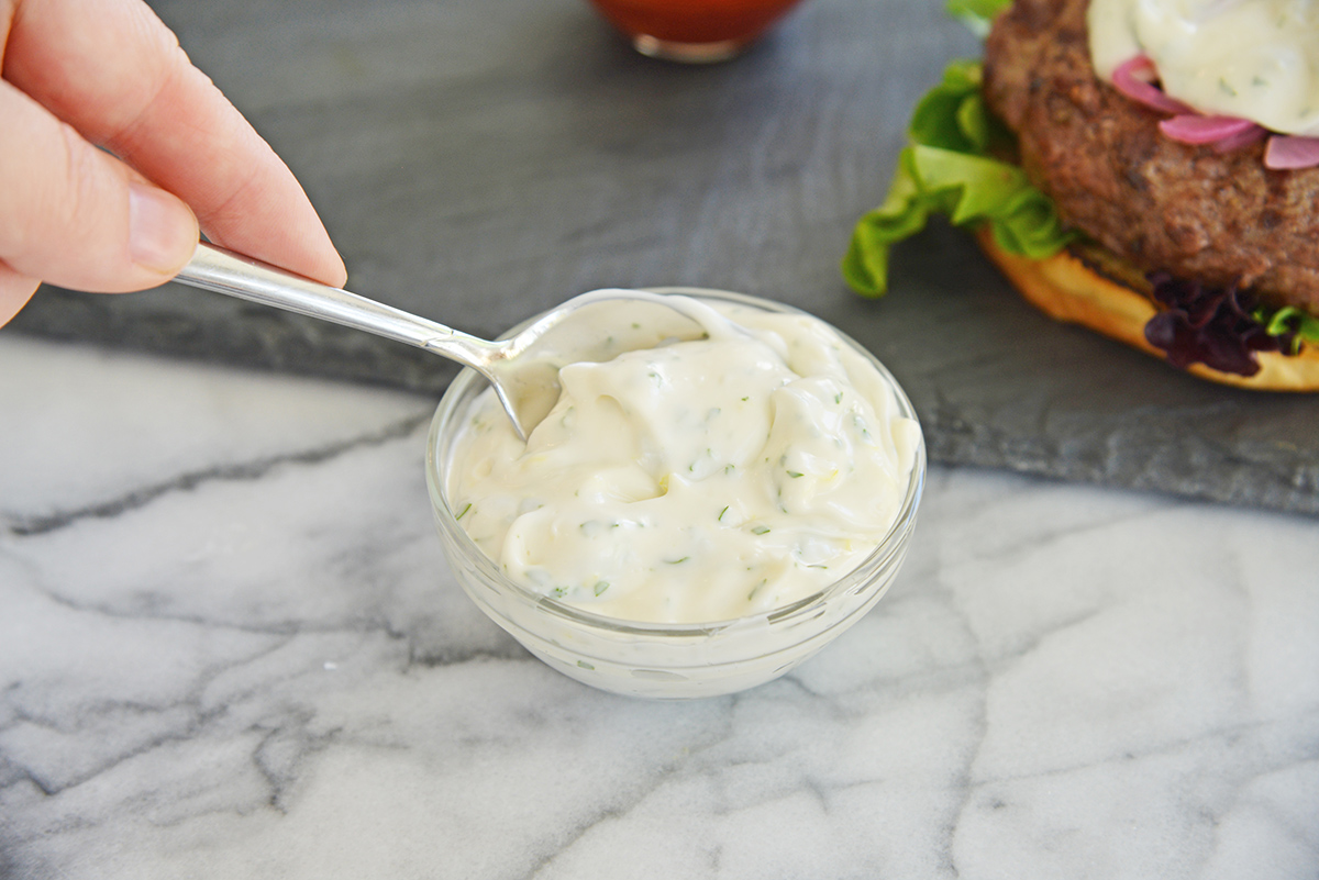 spoon in bowl of tzatziki sauce