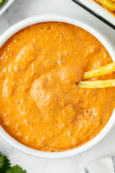 two french fries in bowl of chipotle mayo