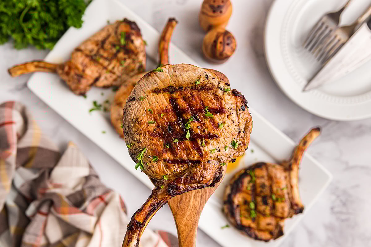 close up overhead shot of pork chop on spatula