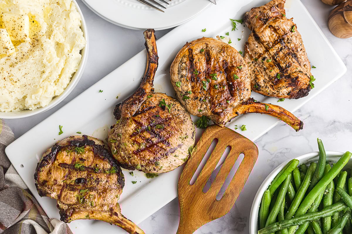 overhead shot of onion grilled pork chops on platter