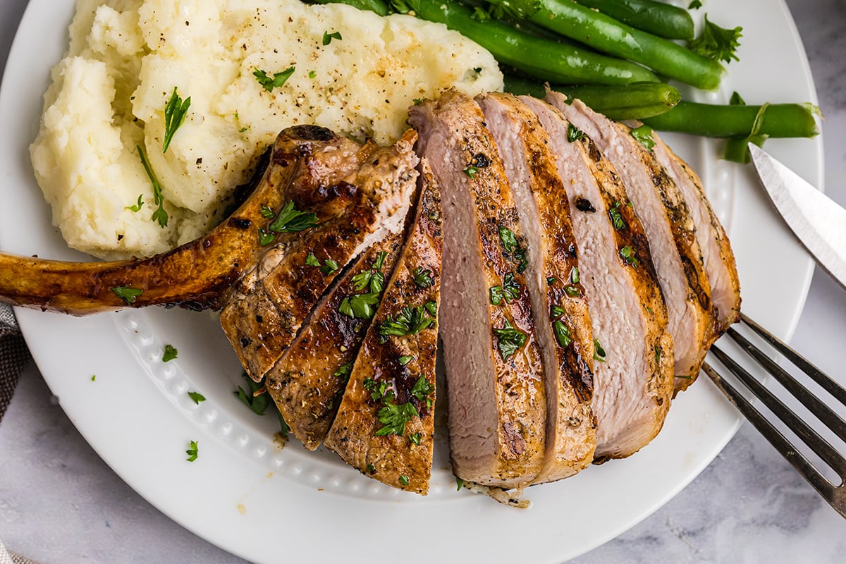 overhead shot of sliced pork chop on plate