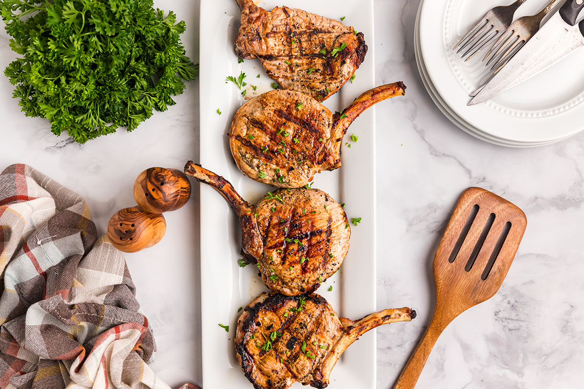 overhead shot of four pork chop on platter