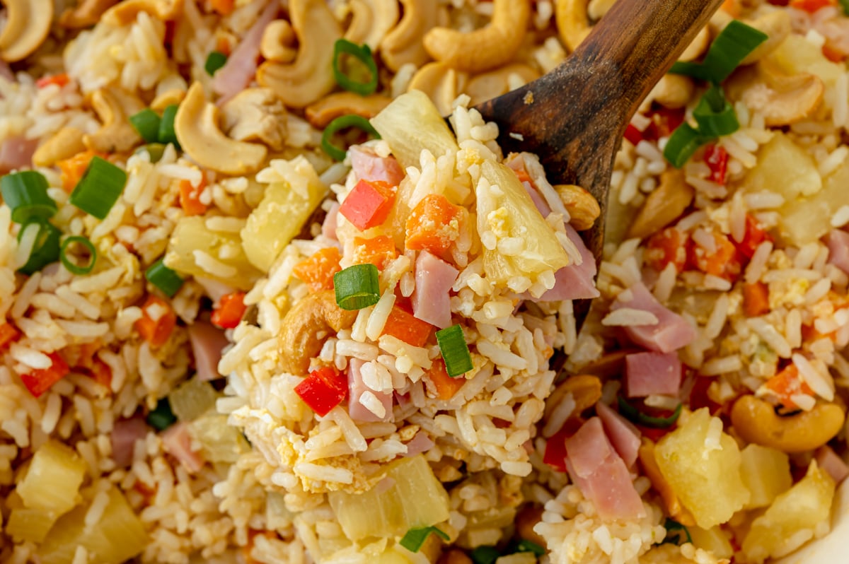close up shot of serving spoon full of pineapple fried rice