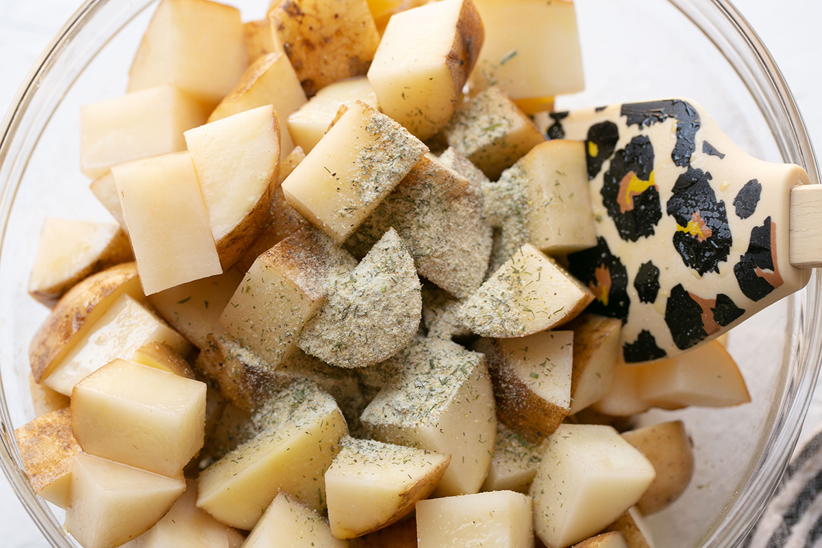 dry ranch seasoning added to bowl of potatoes