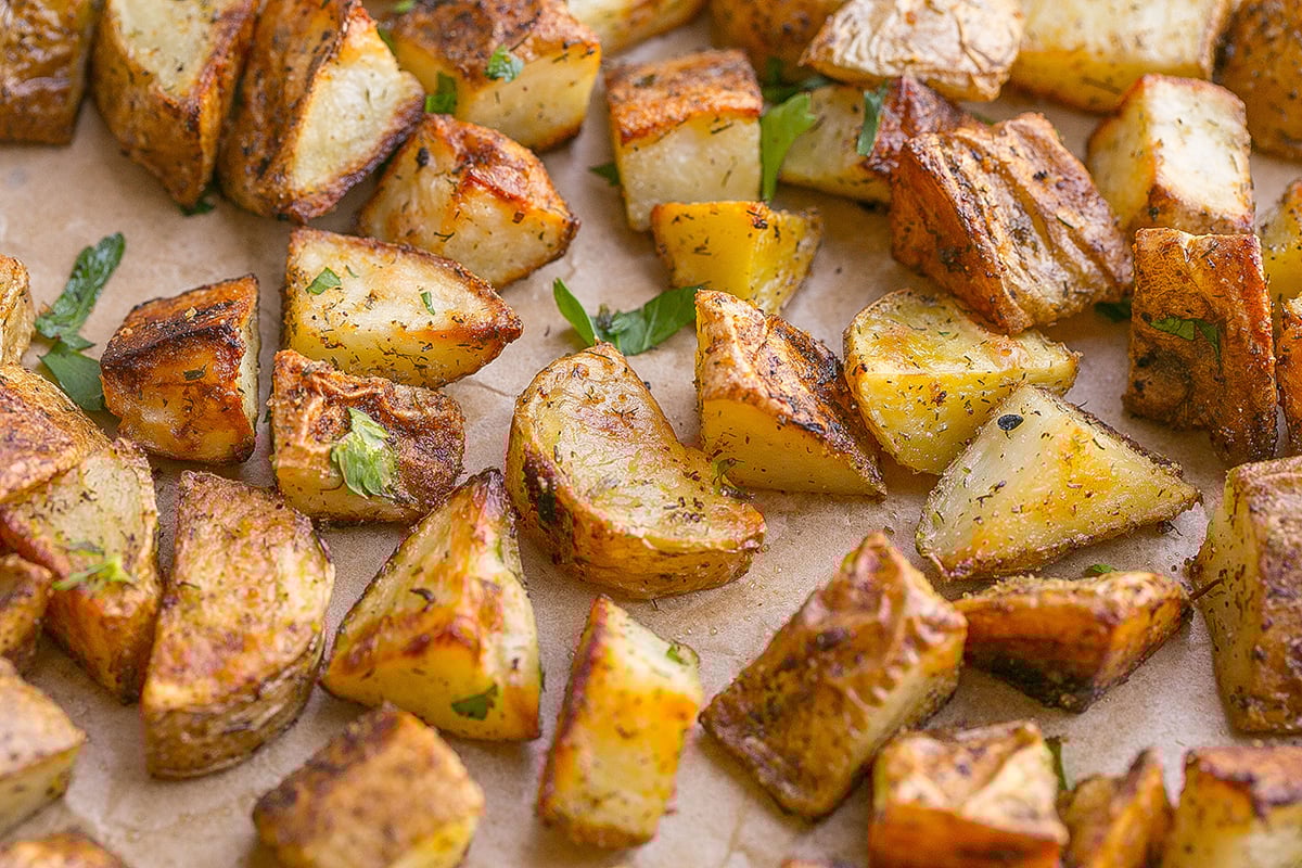 close up angled shot of ranch potatoes on baking sheet