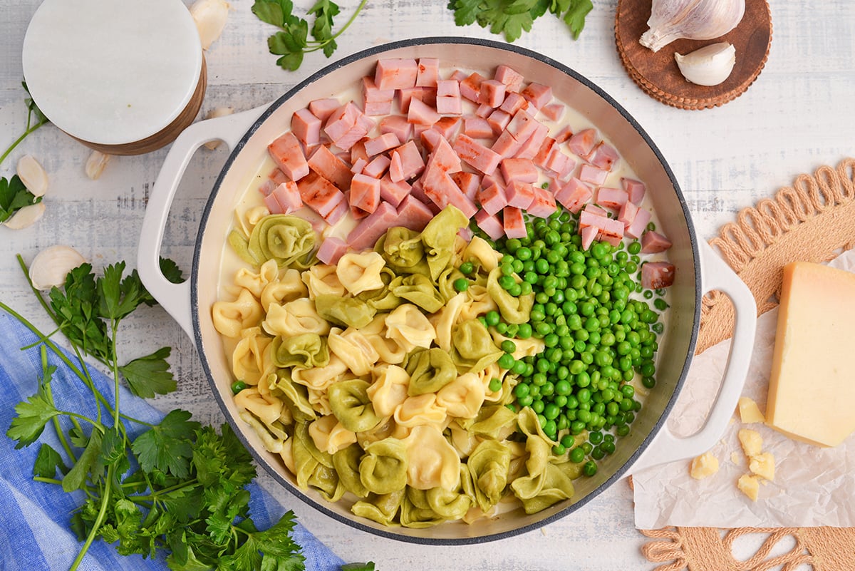 overhead shot of ham and cheese tortellini ingredients in pan