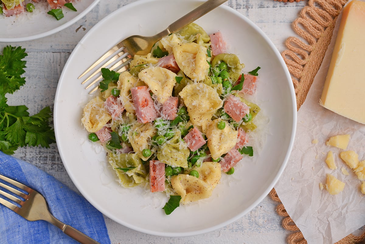 close up overhead shot of bowl of tortellini with ham
