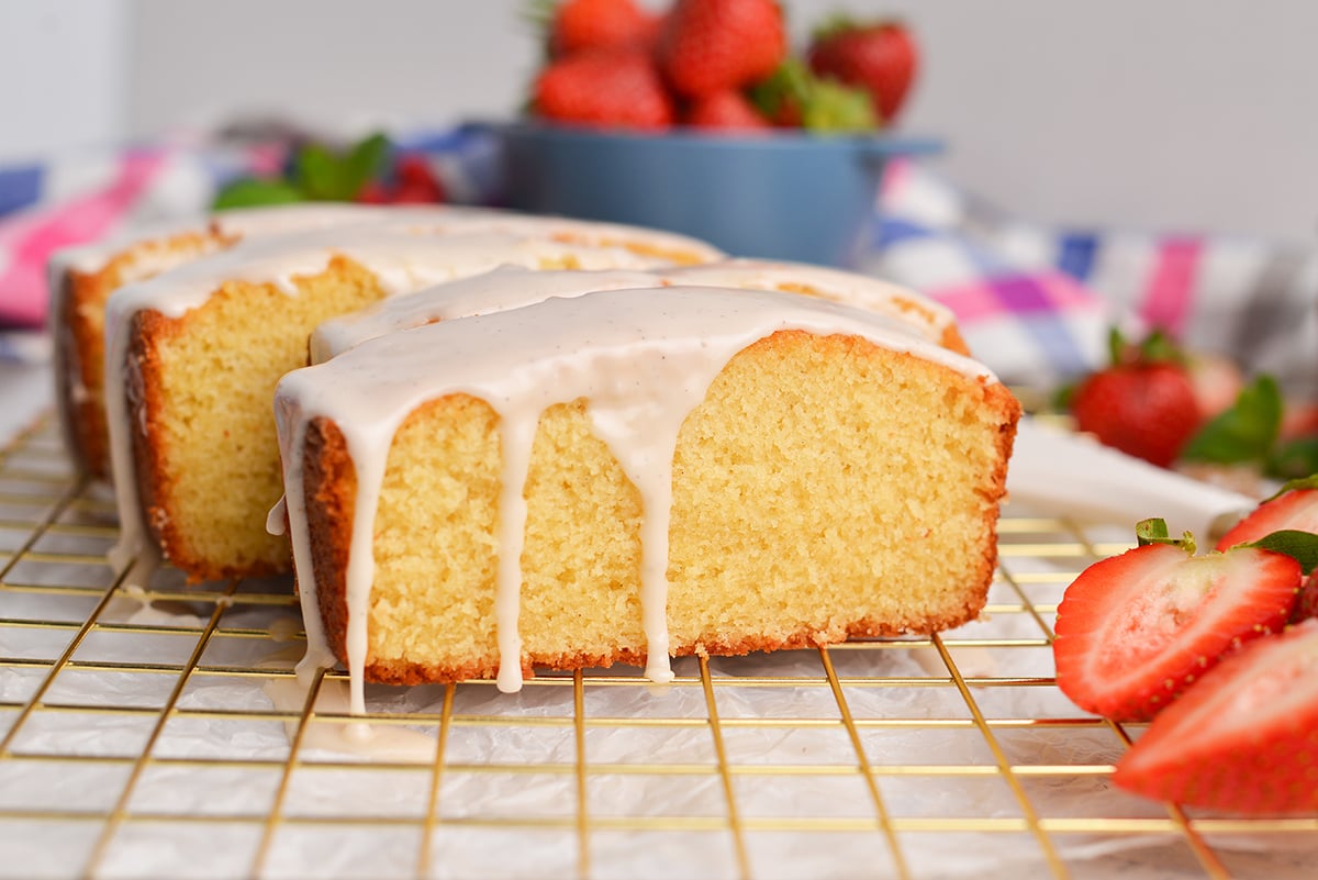 straight o shot of glaze dripping on vanilla pound cake slices