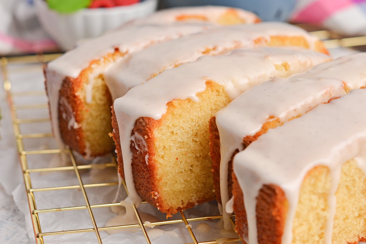 angled shot of sliced pound cake topped with glaze
