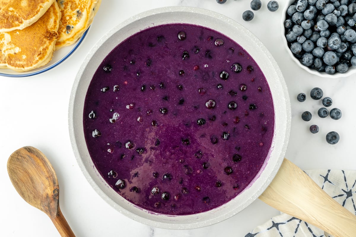 overhead shot of saucepan of homemade blueberry syrup