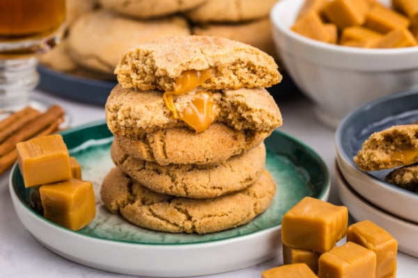 stack of caramel apple cookies on apple with caramels