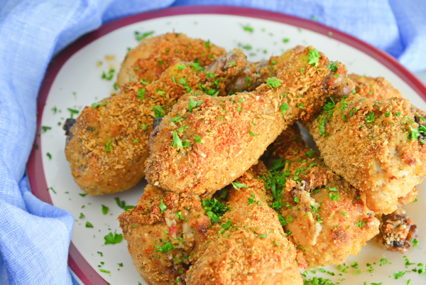 serving platter of oven fried chicken with parsley garnish