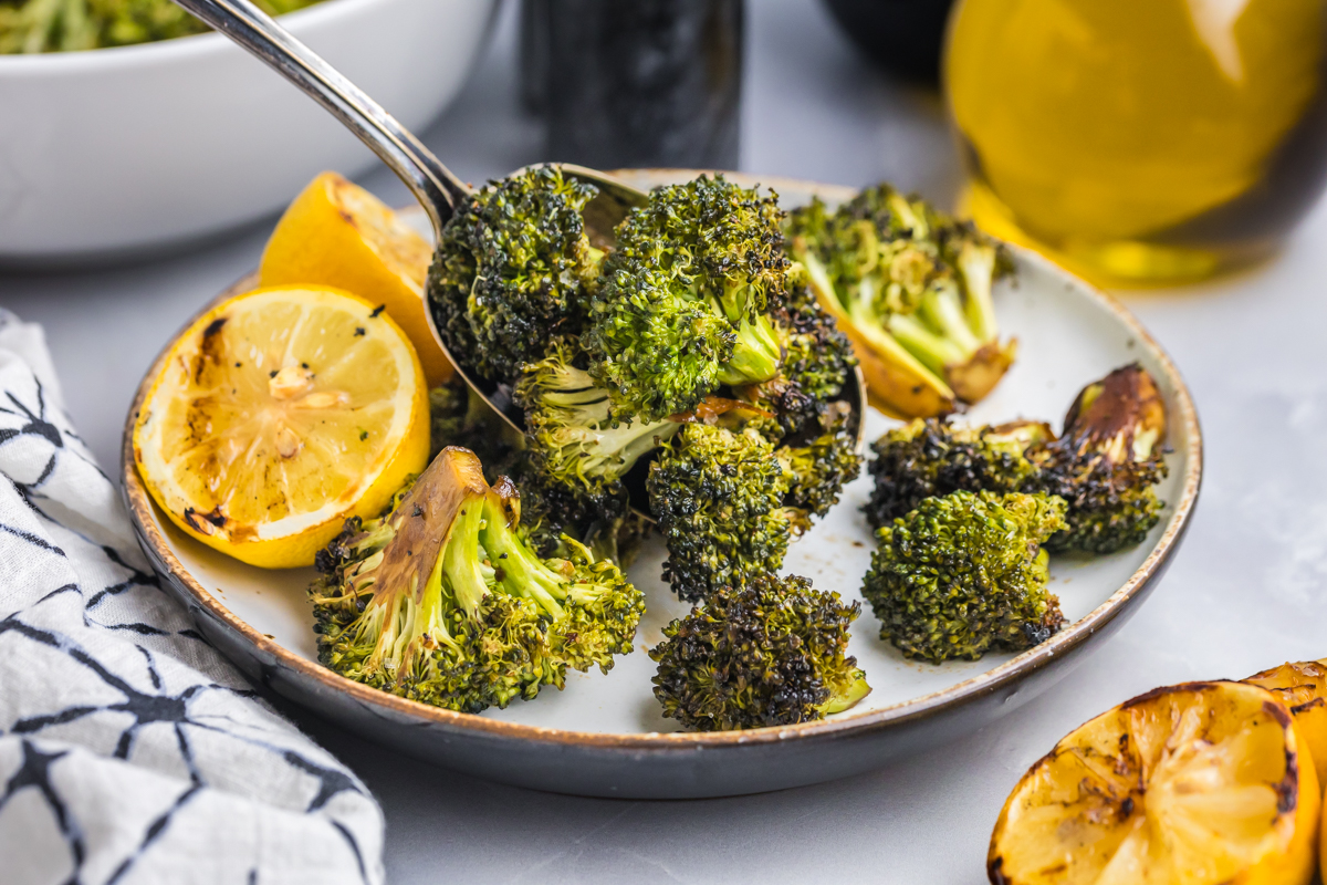 straight on shot of spoon full of grilled broccoli
