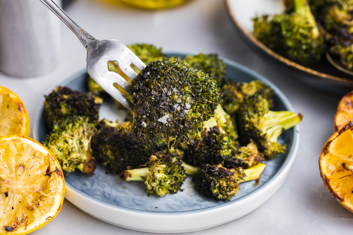 angled shot of bite of grilled broccoli on fork