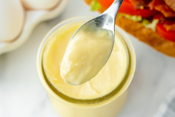 close up overhead shot of spoon full of mayo