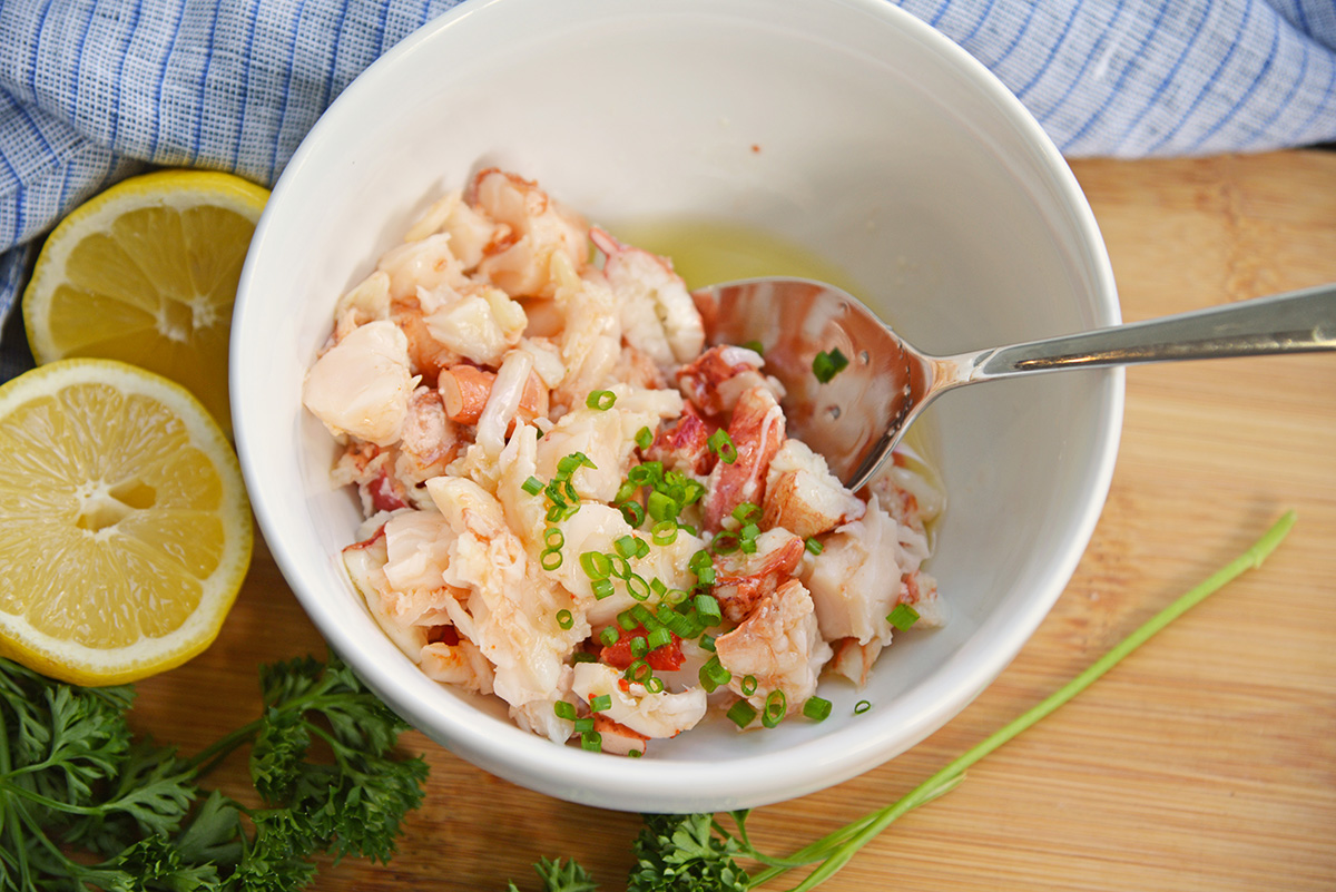 bowl of lobster tossed with butter and chives