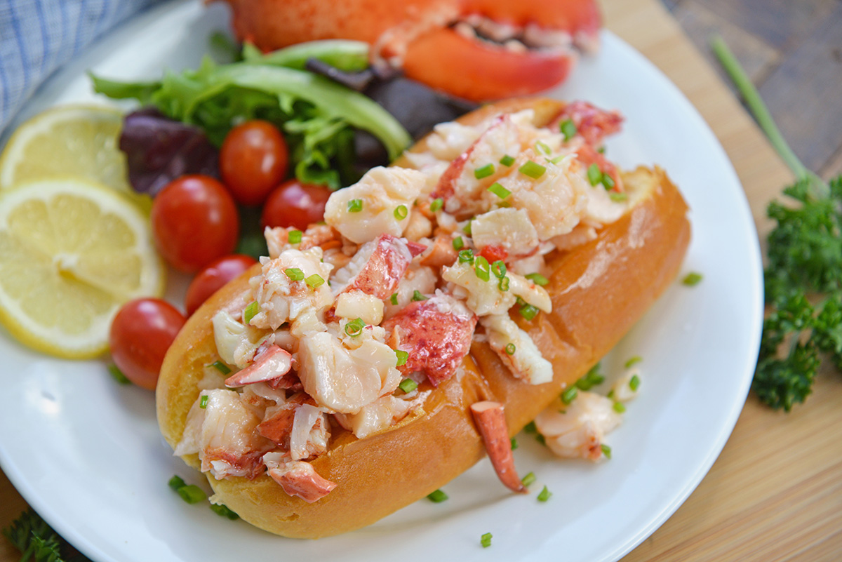 angled shot of hot lobster roll on plate