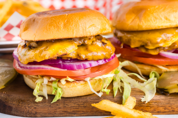 straight on shot of two smash burgers on wooden board