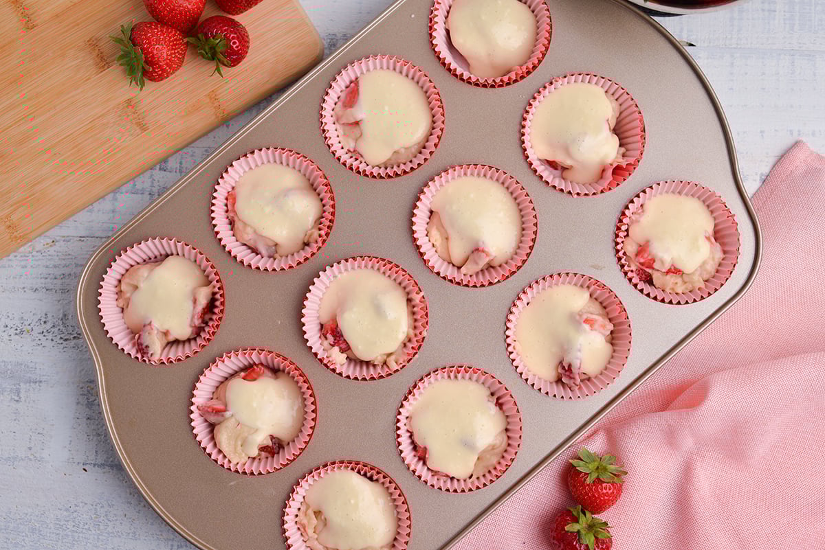 cream cheese mixture on muffin batter in pan