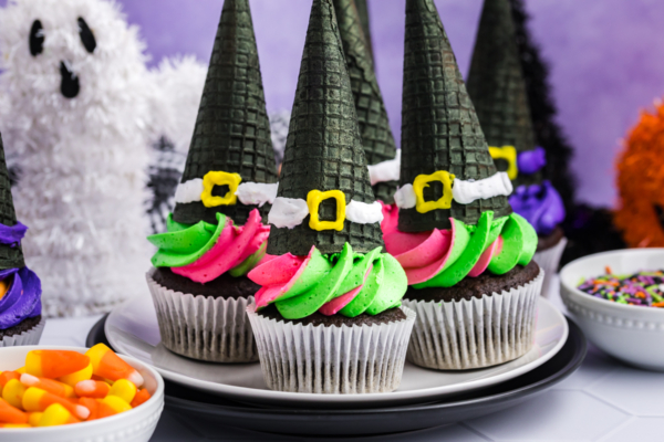 plater of green and pink frosted witch hat cupcakes