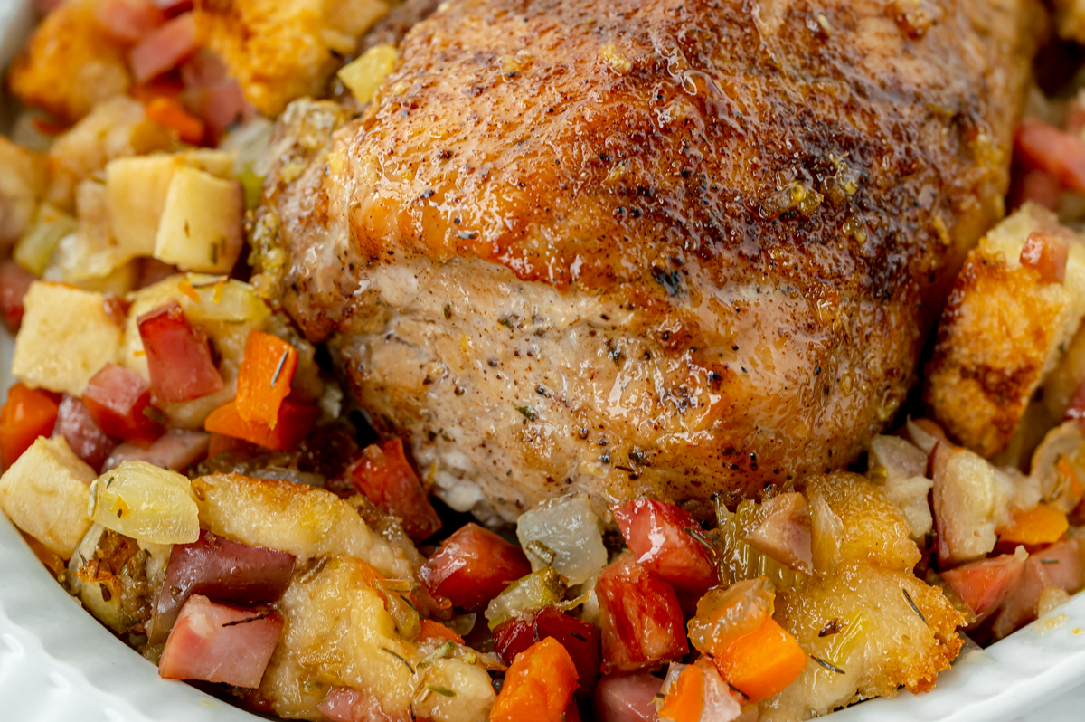 close up angled shot of apple spiced pork tenderloin in stuffing