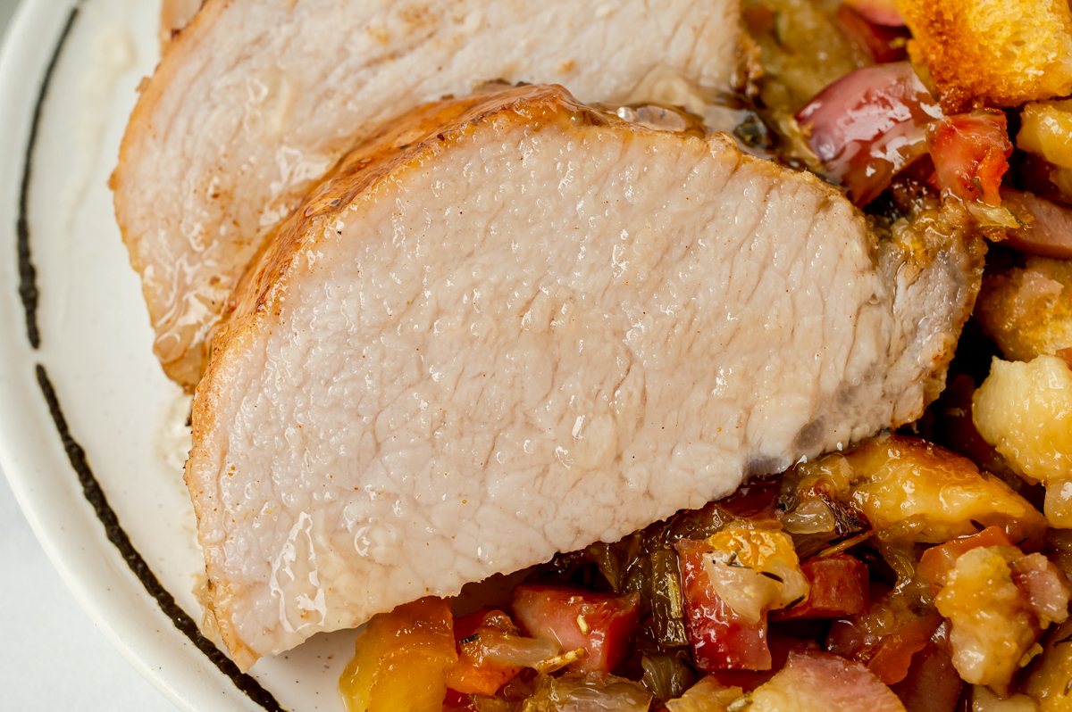 close up shot of slice of apple spiced pork tenderloin
