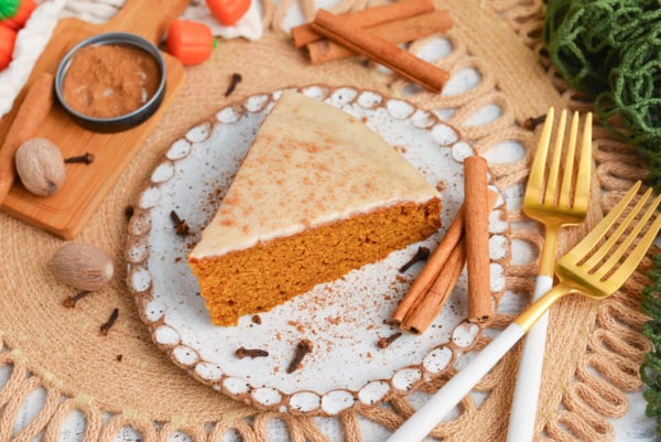 angled shot of slice of pumpkin olive oil cake on plate