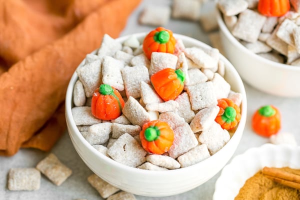 angled shot of white bowl of pumpkin spice puppy chow