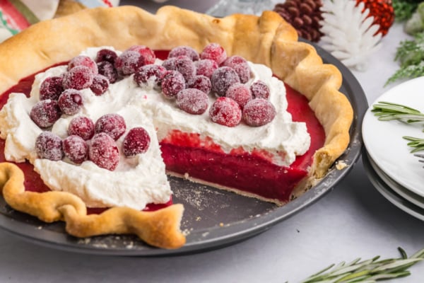 angled shot of slice taken out of cranberry pie