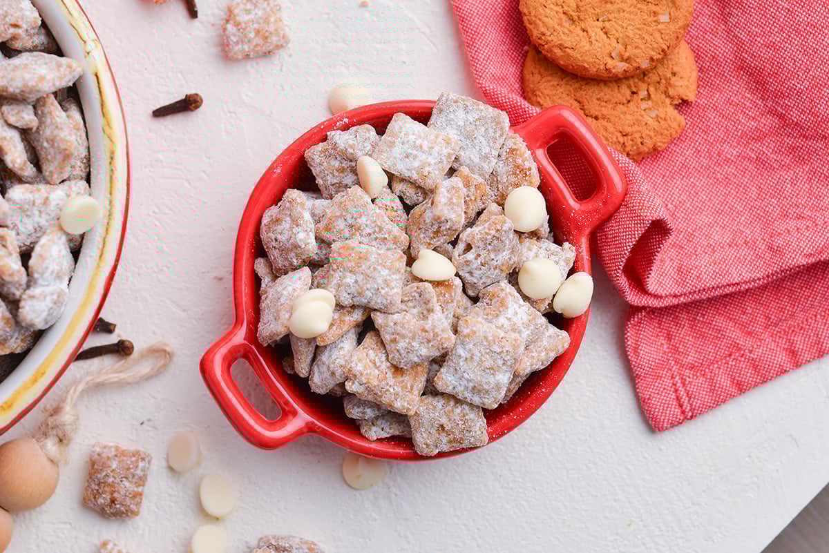 overhead shot of red bowl full of christmas puppy chow