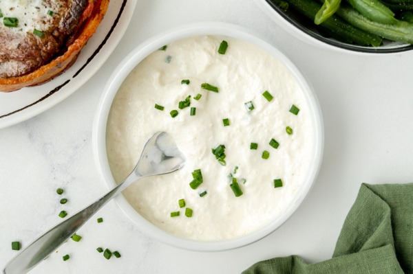 spoon in bowl of horseradish cream sauce