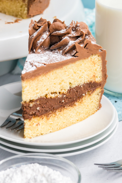 angled shot of slice of brown butter cake on stack of plates